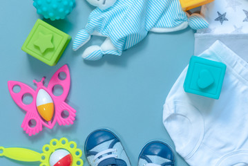 Baby clothes and toys abstract background with a copy space.