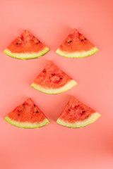 Watermelon slices on a pink background. Healthy food concept.