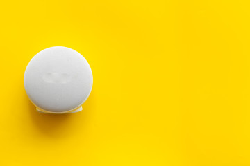 Portable wireless speakers as gadgets for listen to the music on yellow background top view space for text