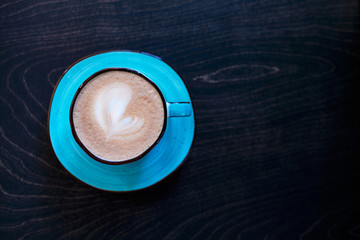 Fresh flavored coffee art on wooden background.