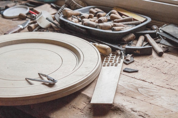 Vintage woodworking tools and wooden unfinished plate, on a workbench, dust and shavings: carpentry, craftsmanship and handwork concept. part of the frame.