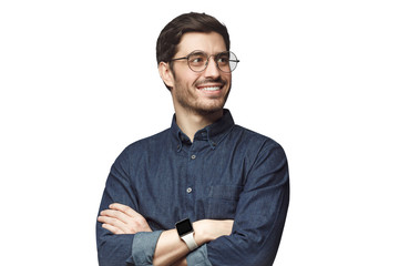 Young man looking away standing with crossed arms, wearing round glasses, isolated on white