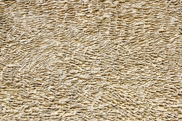 Stucco wall. Relief plaster. Sepia. Texture. Background. Close up. Copy space.