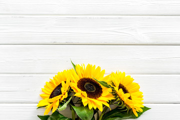 Beautiful yellow sunflowers on white wooden background top view mock up
