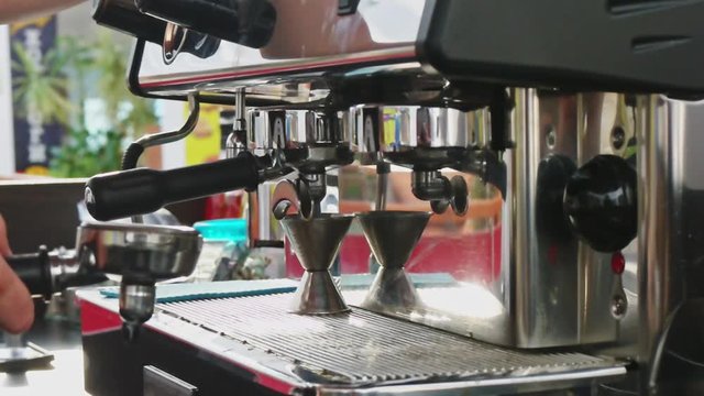Barista making a coffee on professional coffee machine