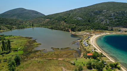 Fototapeta premium Aerial drone photo of iconic paradise bay and sandy beach of Porto Koufo with turquoise calm sea protected by winds, South Sithonia Peninsula, North Greece