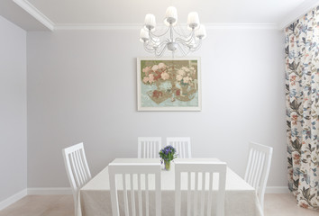 photo of epmty minimalistic interior background, kitchen in modern apartment with big table, chairs, flowers, painting, chandelier and curtain