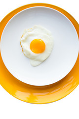 Fried egg on a white, yellow plate. Top view. Restaurant. Breakfast