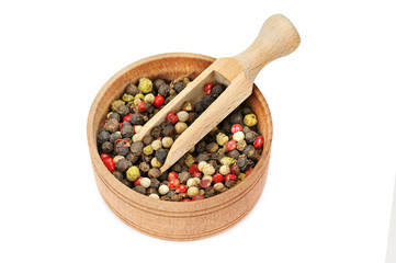 A mixture of allspice in wooden cup isolated on white background.