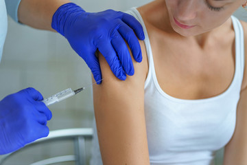 A nurse vaccinates a patient during an epidemic of influenza, measles and viral infections