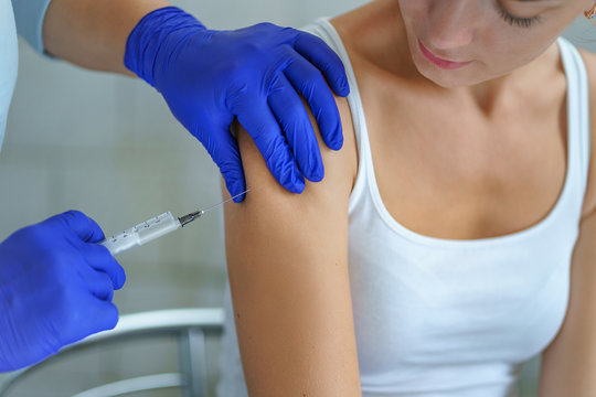 A nurse vaccinates a patient during an epidemic of influenza, measles and viral infections