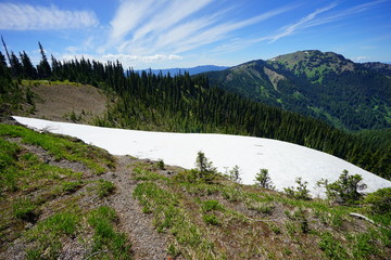 Beautiful cloud over snow capped mountains in Olympic National Park in summer in Washington, near Seattle