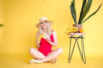 Portrait of a cheerful young girl wear straw hat and red swimwear