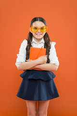 This is my book. small child with notebook. literature lesson education. writing in workbook. children literature. get information from book. happy school girl in uniform and party glasses