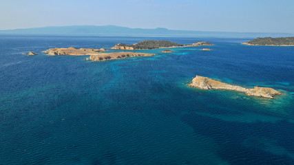 Fototapeta na wymiar Aerial drone view of paradise small secluded island complex of Drenia and Pena with turquoise and sapphire sea near famous Amouliani island in North Greece, Halkidiki