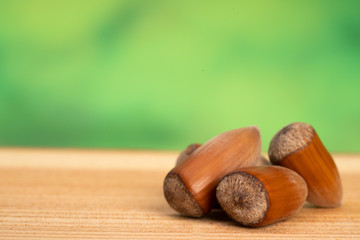 group hazelnuts on wood and green backgroun