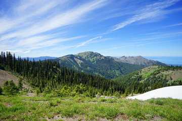 Fototapeta na wymiar Beautiful cloud over snow capped mountains in Olympic National Park in summer in Washington, near Seattle