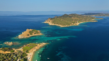 Fototapeta na wymiar Aerial drone view of paradise small secluded island complex of Drenia and Pena with turquoise and sapphire sea near famous Amouliani island in North Greece, Halkidiki