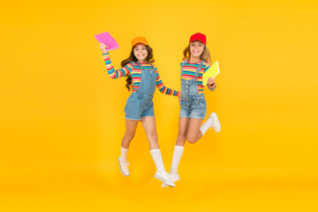 Generate positive energy, encourage active participation. Lets study. Back to school. Excited about studying. Study groups help students learn material deeper. Kids girls with books study together