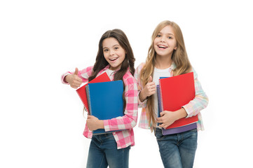 We love study. School stationery. Pupils carrying big textbooks to school classes. Taking extra classes. Girls with school textbooks white background. Happy to be students. School supplies concept