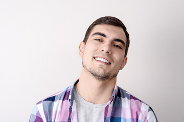 portrait of smiling handsome man on grey background