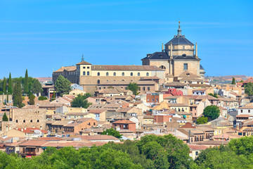 Colorful cityscape view of the San Juan Bautista Tavera Hospital renaissance building of the medieval city of Toledo, Castilla la Mancha, Spain. UNESCO world heritage site.