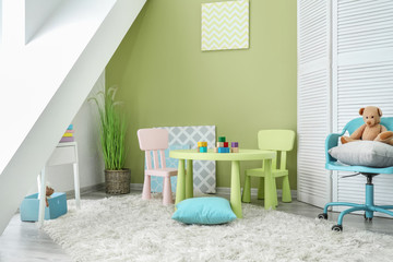 Stylish interior of modern playroom in kindergarten