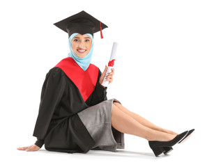 Muslim female graduate with diploma on white background