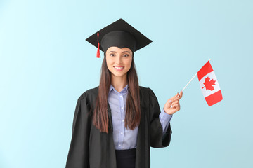 Female graduate with Canadian flag on color background