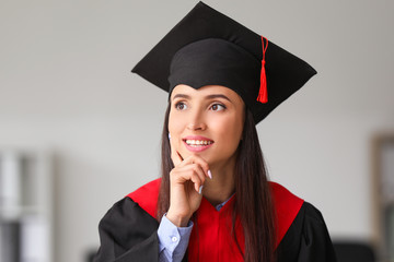 Happy female graduate at the university