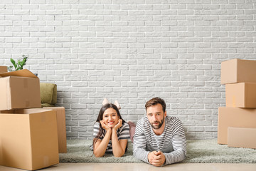Young couple with belongings after moving into new house