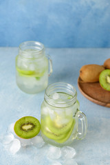 Mason jar of tasty kiwi cocktail on table