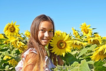 Teenage girl on a field of sunflowers.