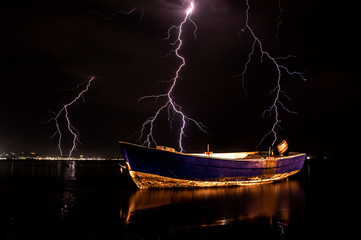 Boat with storm lightning background. Durres Albania 2019