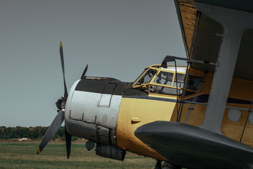 Fototapeta na wymiar Old retro airplane propeller and cockpit close up, vintage toned