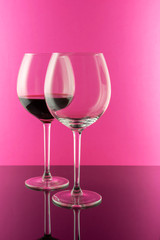 Studio shot of a glass of red wine isolated on pink background closeup. Clean and minimal. Wine concept. 