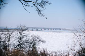 Fototapeta na wymiar Bridge over the frozen river in Cherkassy