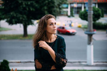 Beautiful young girl in a summer evening in the city