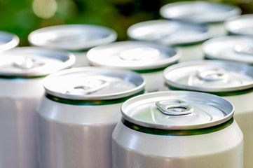Aluminum closed white cans with beer close-up