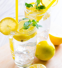 Glasss of mojito with lemon and drinking straw