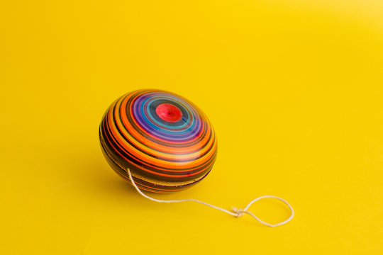 mexican toys, yoyo from Wooden in Mexico on yellow background