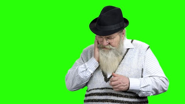 Old man having toothache on green screen. Aged caucasian man suffering from tooth pain. Alpha Channel background.