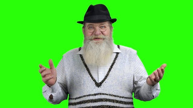 Surprised old happy man on green screen. Happy shocked senior man celebrating success with raised hands. Jackpot, earnings, victory concept.
