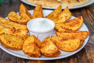 fried potatoes with Mexican sauce on the plate