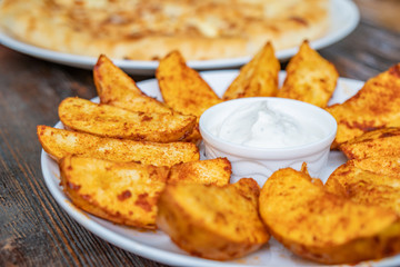fried potatoes with Mexican sauce on the plate