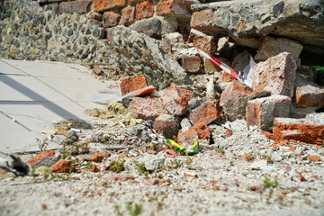 Broken brick and rubbish next to an old ruined building. Dump