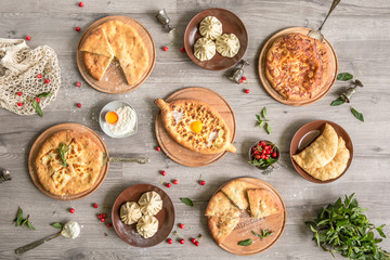 Food Table Celebration Delicious Party Meal Concept. A lot of food on the wooden table: meat, vegetables, desserts, garnishes.  Foodset from Georgian dishes. Caucasian food