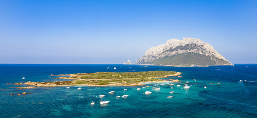 View from above, stunning aerial view of the beautiful Tavolara Island with its beach bathed by a...