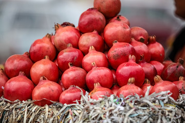 A pyramid of pomegranates at a local farmers market
