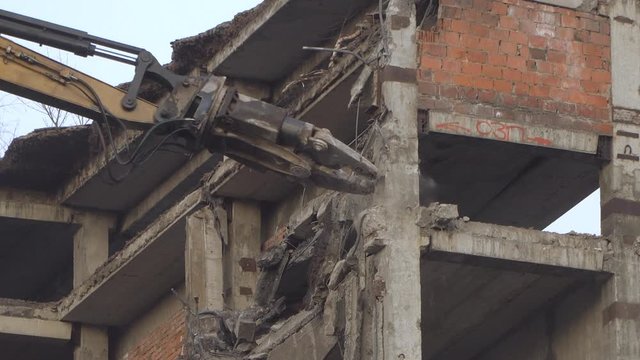demolition of a multi-storey building with hydraulic shears, for future development of residential buildings